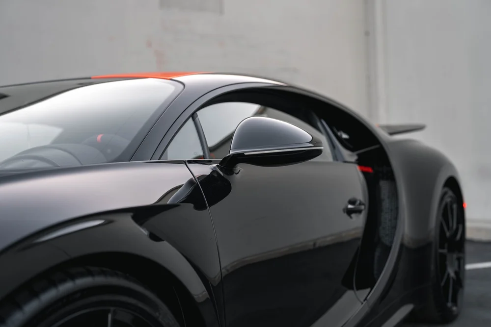 Bugatti Chiron Super Sport 300+ side mirror and curved door in a landscape close view