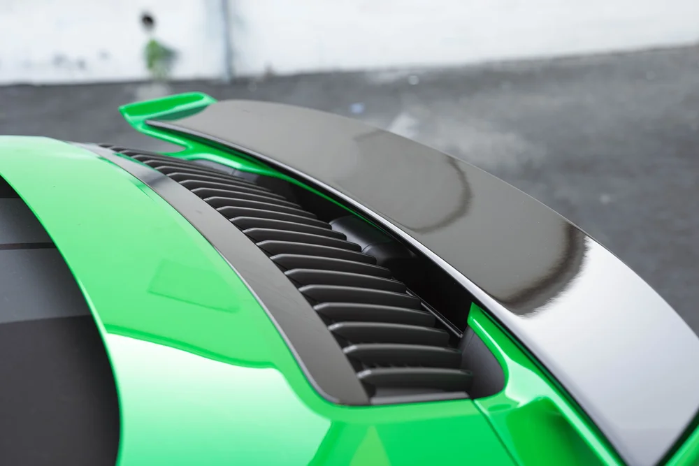 Signal Green Porsche 911 Turbo S, raised rear spoiler, dark vent slats and green rear deck
