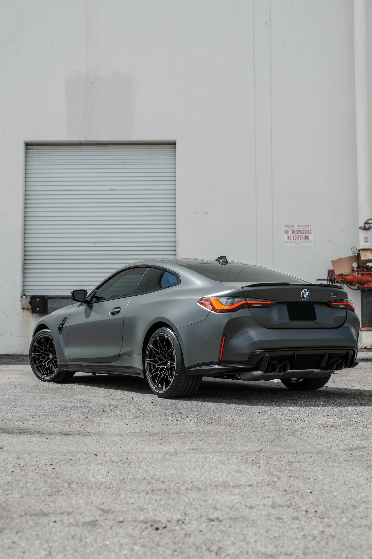 Black BMW M4 after Matte PPF, Window Tint and Ceramic Coating, rear-right three-quarter view
