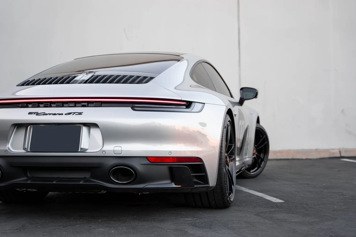 Porsche 911 Carrera GTS (992.1) after Paint Protection Film (PPF), Window Tint, Ceramic Coating and Custom Graphics, rear body and taillight view