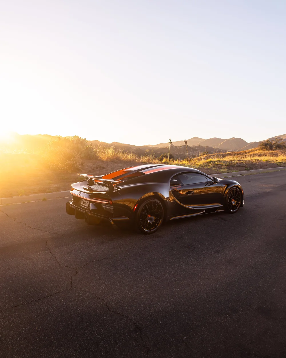Rear three-quarter view of the Bugatti Chiron Super Sport 300+ in warm sunset light