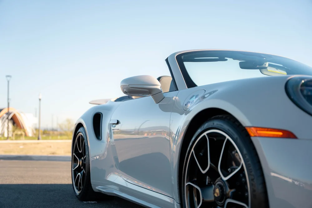 Chalk Porsche 911 Turbo S, low side detail of mirror, windshield frame and reflective door
