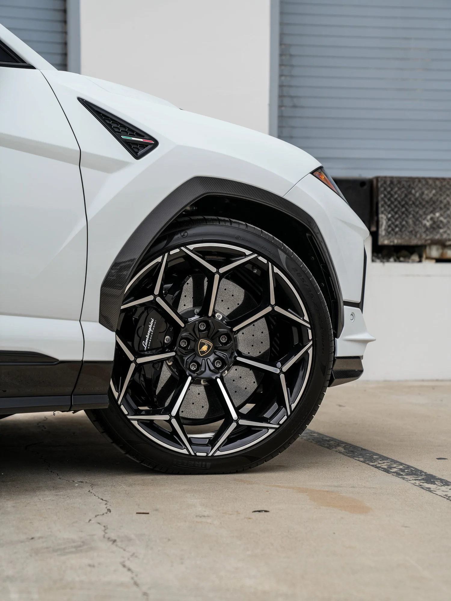 Lamborghini Urus Performante front wheel and carbon-fiber arch detail after full exterior PPF, window tint and ceramic coating