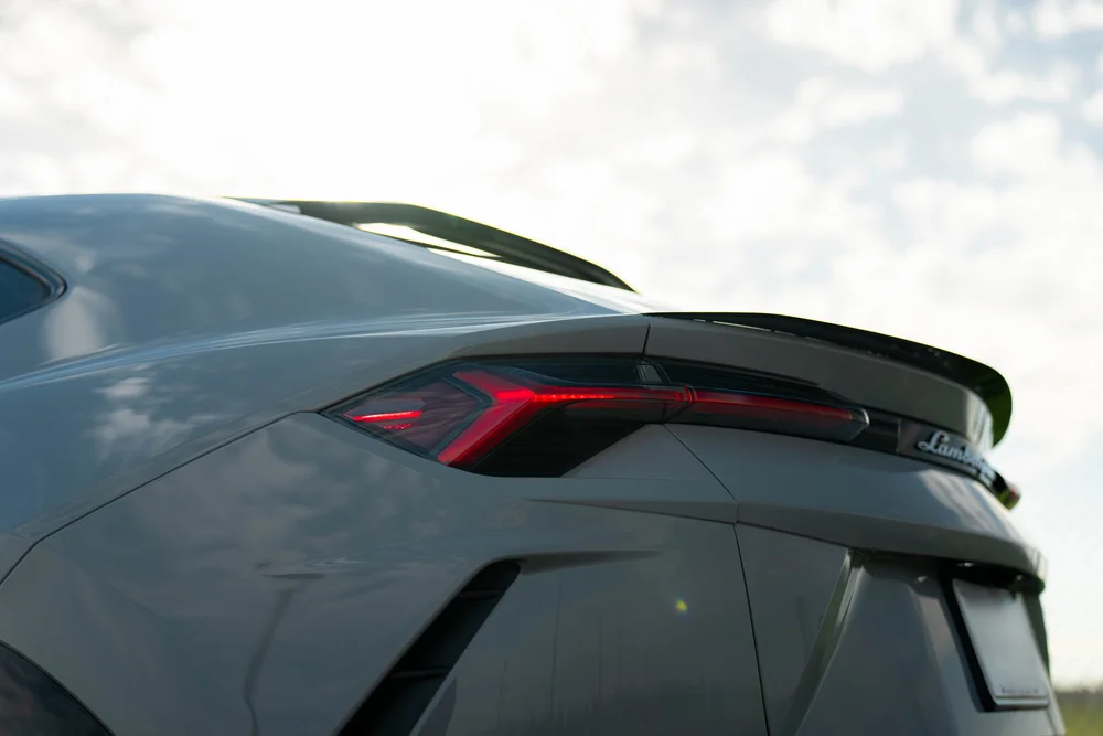 Lamborghini Urus with Chalk vinyl wrap, red rear tail-lamp and black spoiler detail