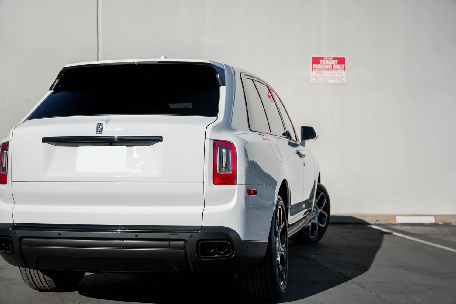 White Rolls-Royce Cullinan after Paint Protection Film (PPF), Window Tint and Ceramic Coating, low-angle rear view
