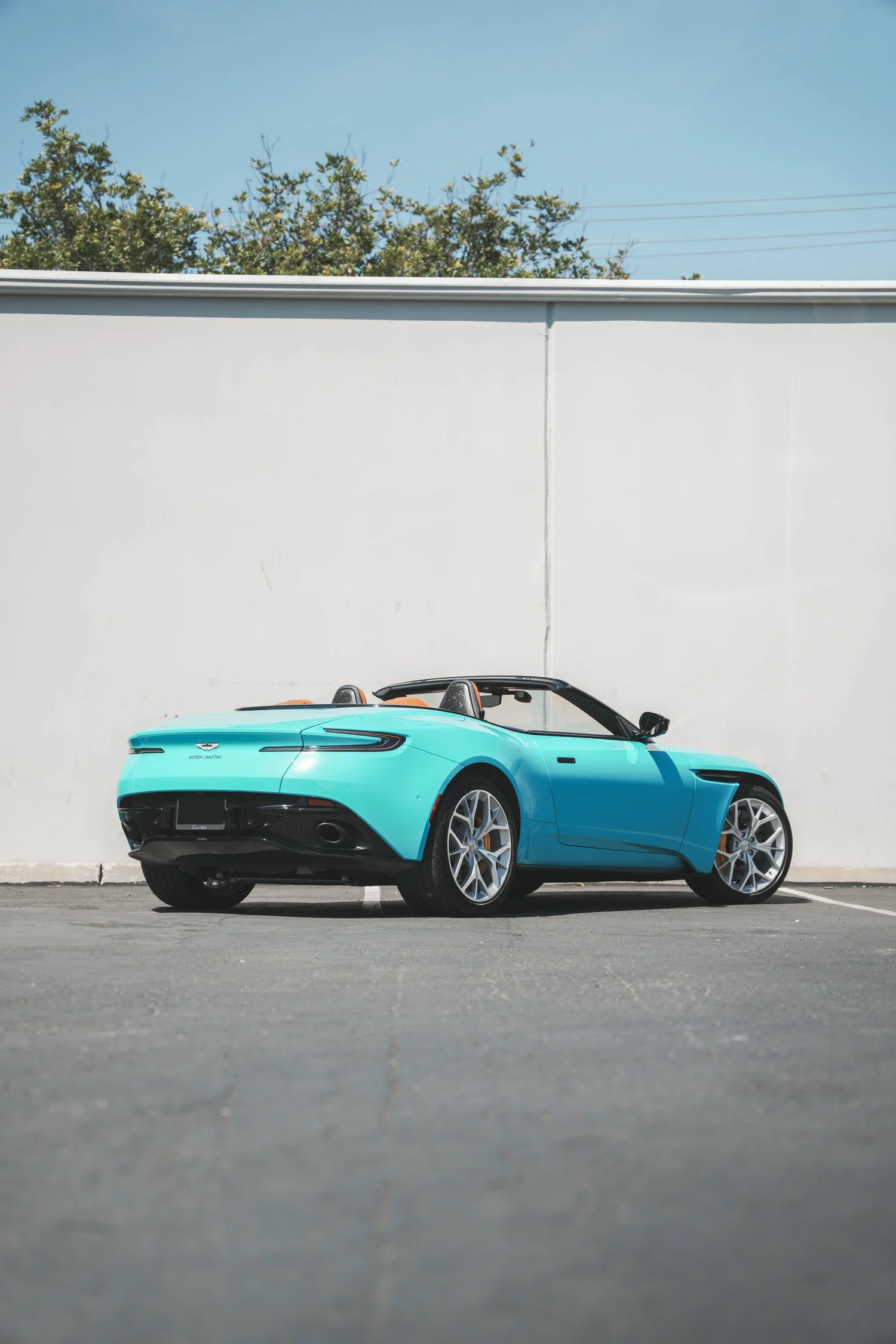 Aston Martin DB11 Miami Blue after Vinyl Wrap, rear-left three-quarter view