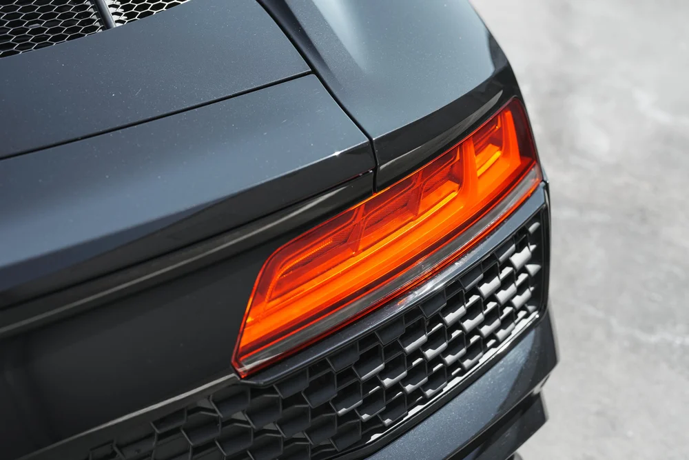 Audi R8 red taillight above the patterned dark rear grille