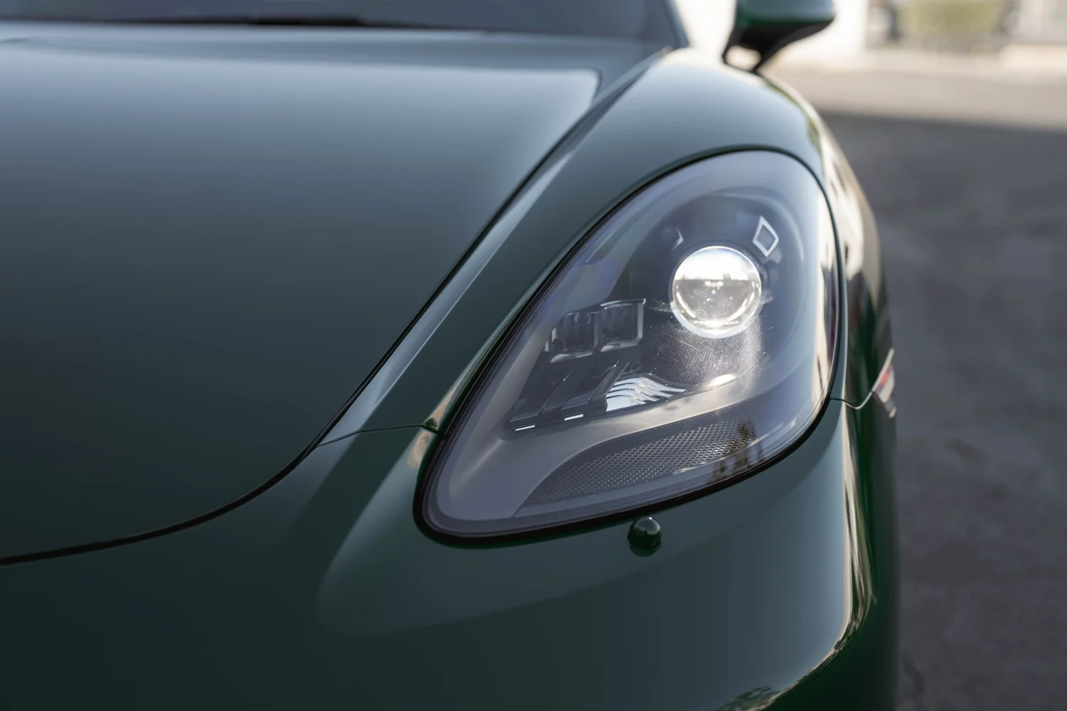 Porsche 718 Cayman S Racing Green after Vinyl Wrap, front bumper and headlight detail