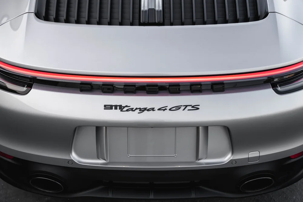 Close-up of the Targa 4 GTS rear badge below the illuminated light strip