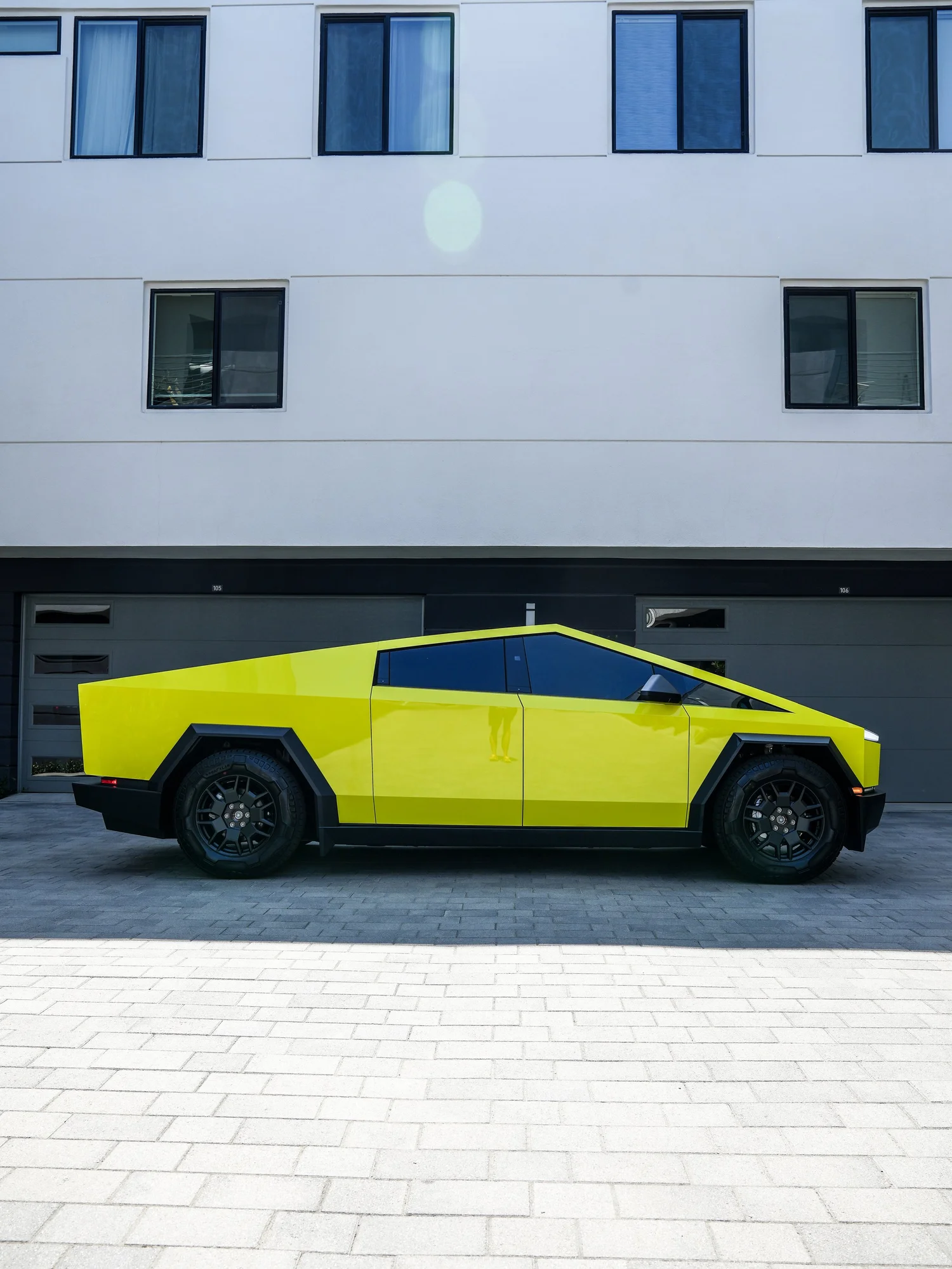 Tesla Cybertruck Inozetek Racing Yellow after Window Tint and Vinyl Wrap, rear-left three-quarter view