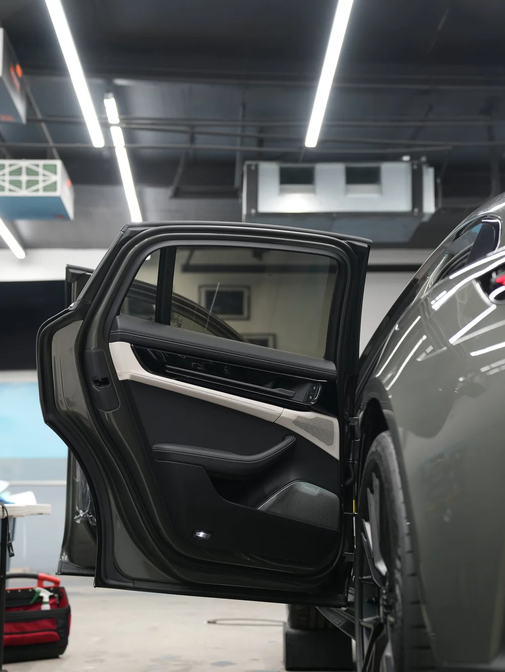 Tinted side glass on a vehicle inside Toyz Detail Studio.