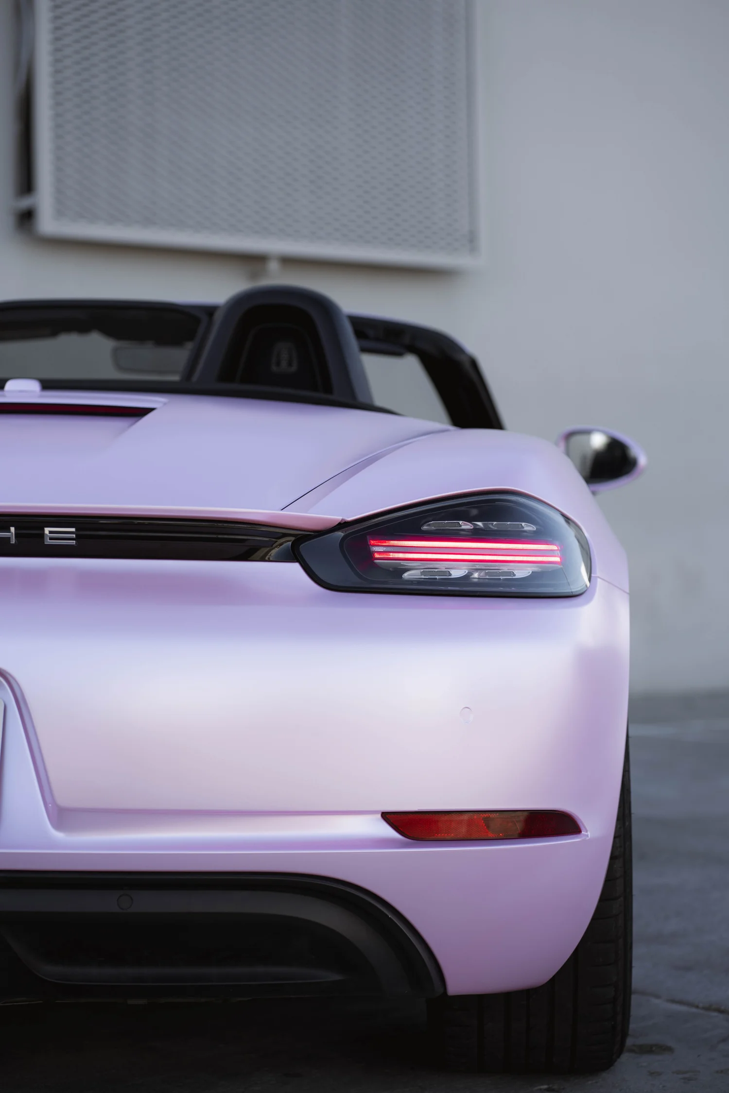 Porsche 718 Boxster Matte Purple Pink after Vinyl Wrap, low-angle rear view