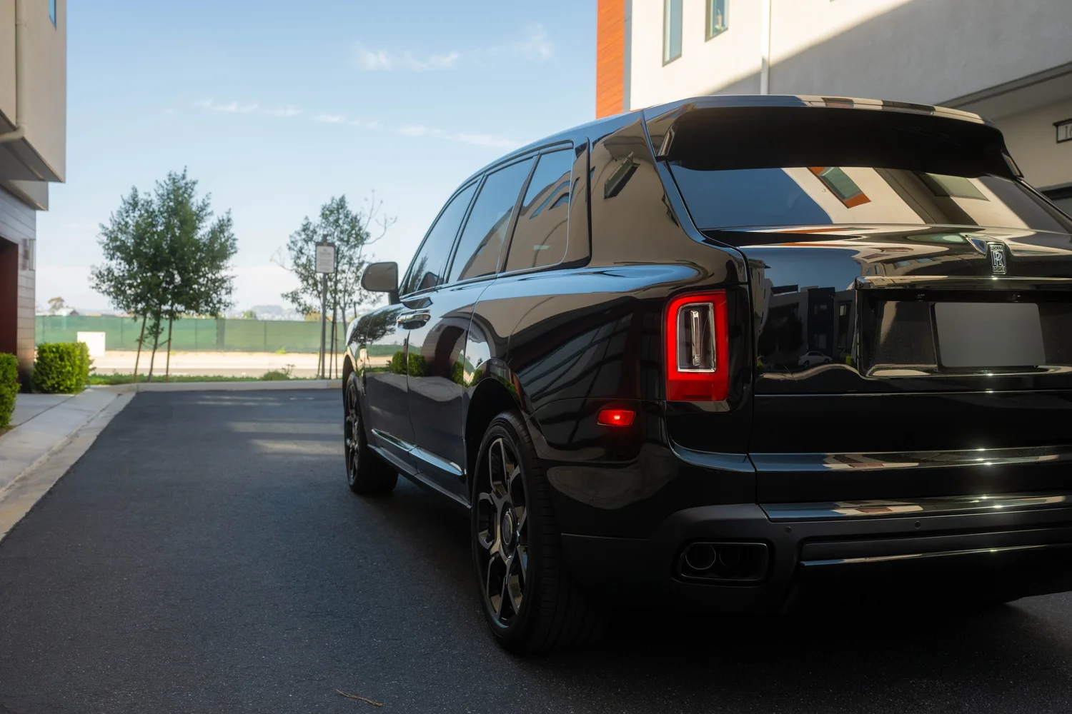 Black Rolls-Royce Cullinan Black Badge with Two-Tone Wheels after Paint Protection Film (PPF), Window Tint and Ceramic Coating, rear-right three-quarter view
