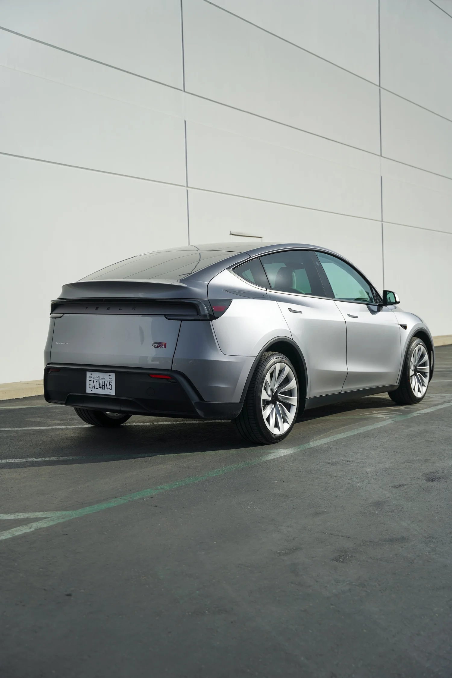 Grey Tesla Model Y after Paint Protection Film (PPF), Window Tint and Ceramic Coating, rear-right three-quarter view