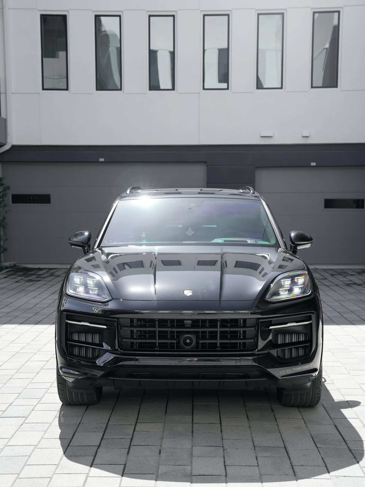 Black Porsche Cayenne GTS after Paint Protection Film (PPF), Window Tint and Ceramic Coating, front-left three-quarter view
