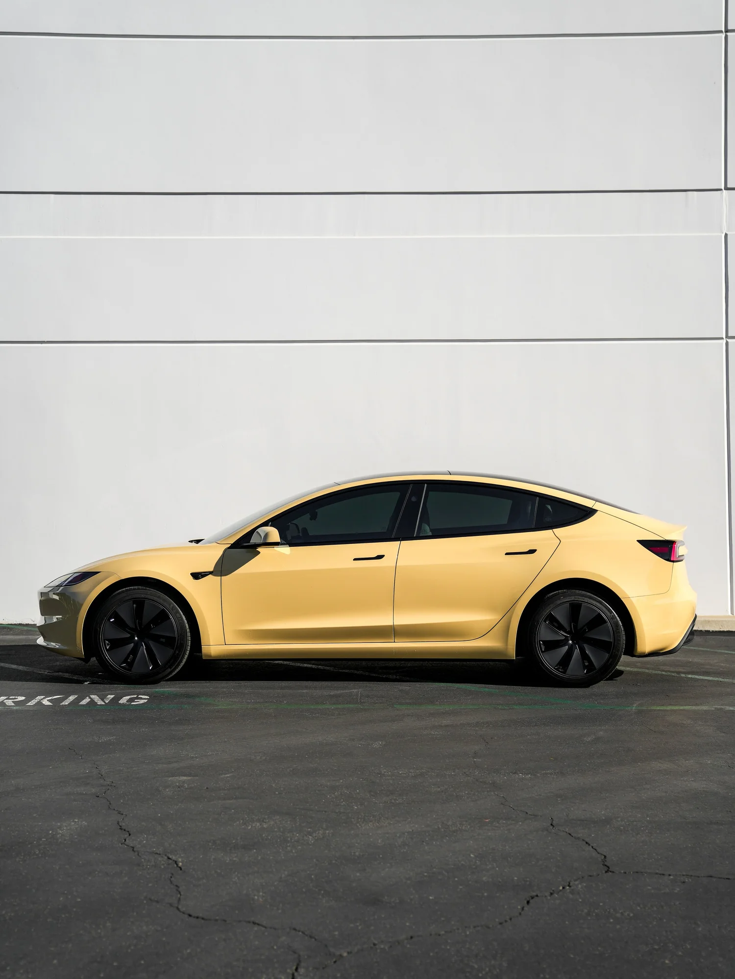 Tesla Model 3 Sunrise Yellow after Vinyl Wrap, left-side profile