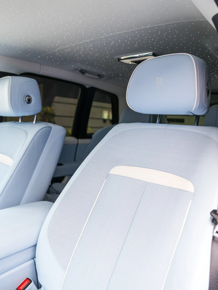 Pale blue Cullinan front seats beneath a headliner dotted with pinpoint lights