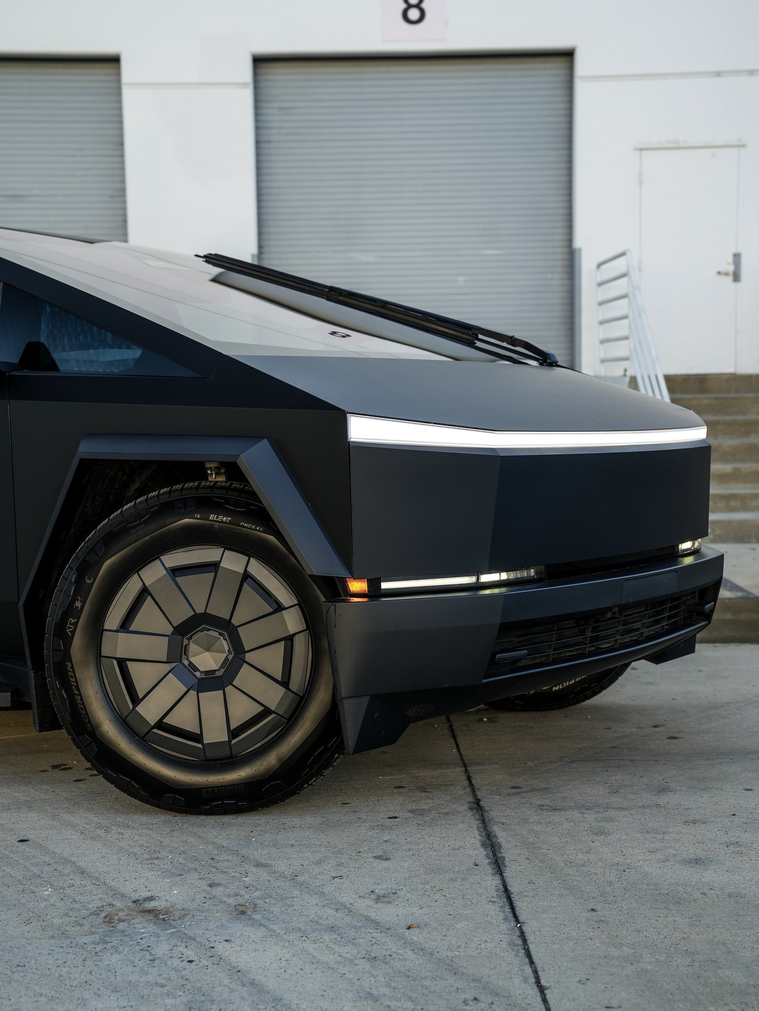 Tesla Cybertruck front wheel and passenger-side nose detail after PROTEK matte black PPF and window tint