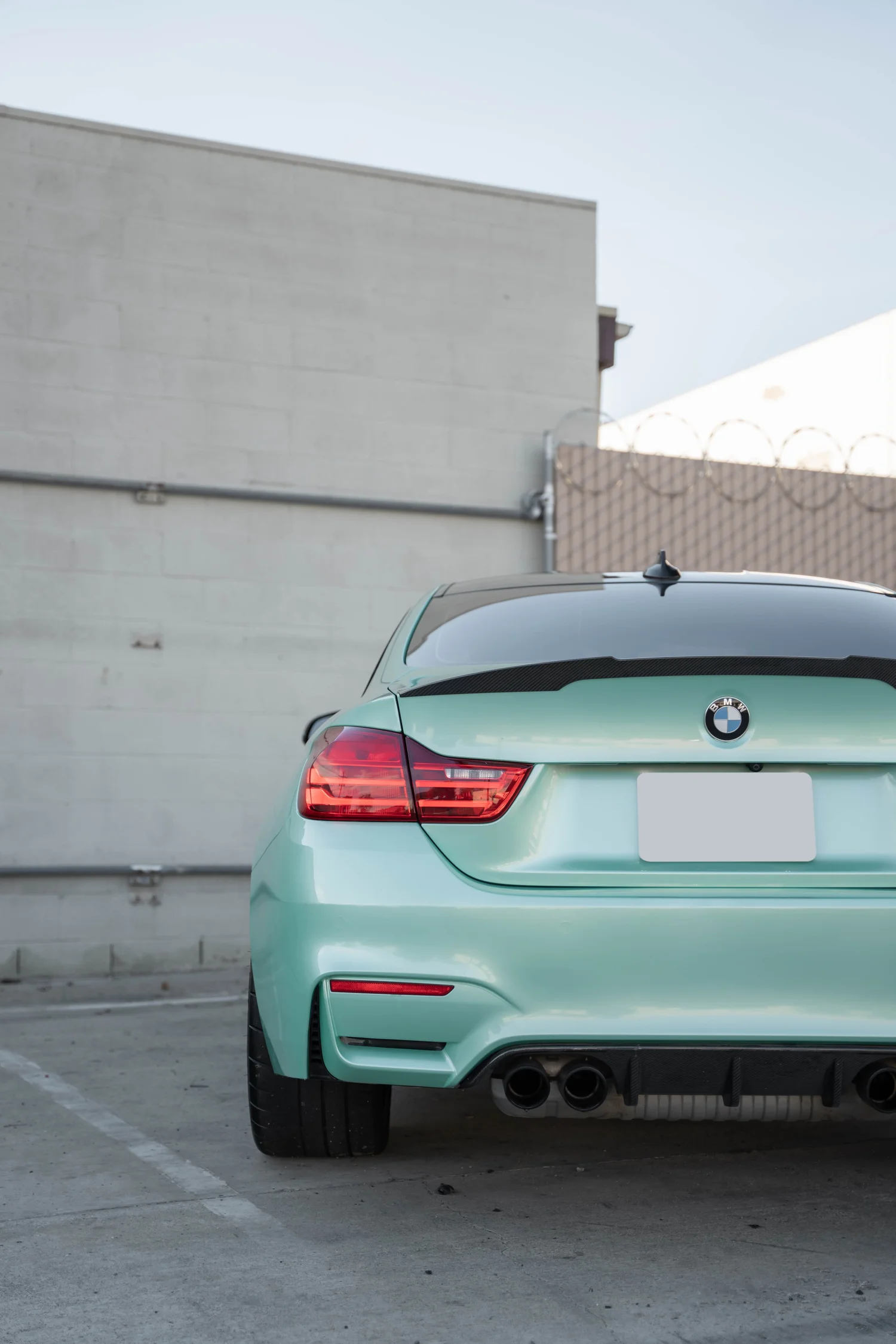 BMW M4 Mint Green after Vinyl Wrap, low-angle rear view
