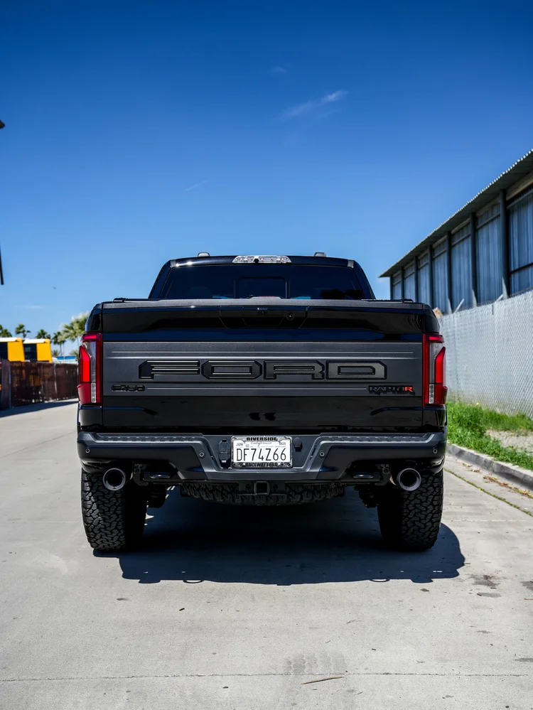 Straight rear view of the Ford F-150 Raptor R with tailgate lettering and twin exhaust outlets.