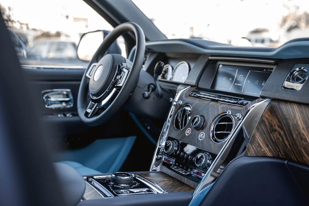 Dark Blue Rolls-Royce Cullinan — front cabin with blue upholstery, wood-pattern dashboard and center-console controls