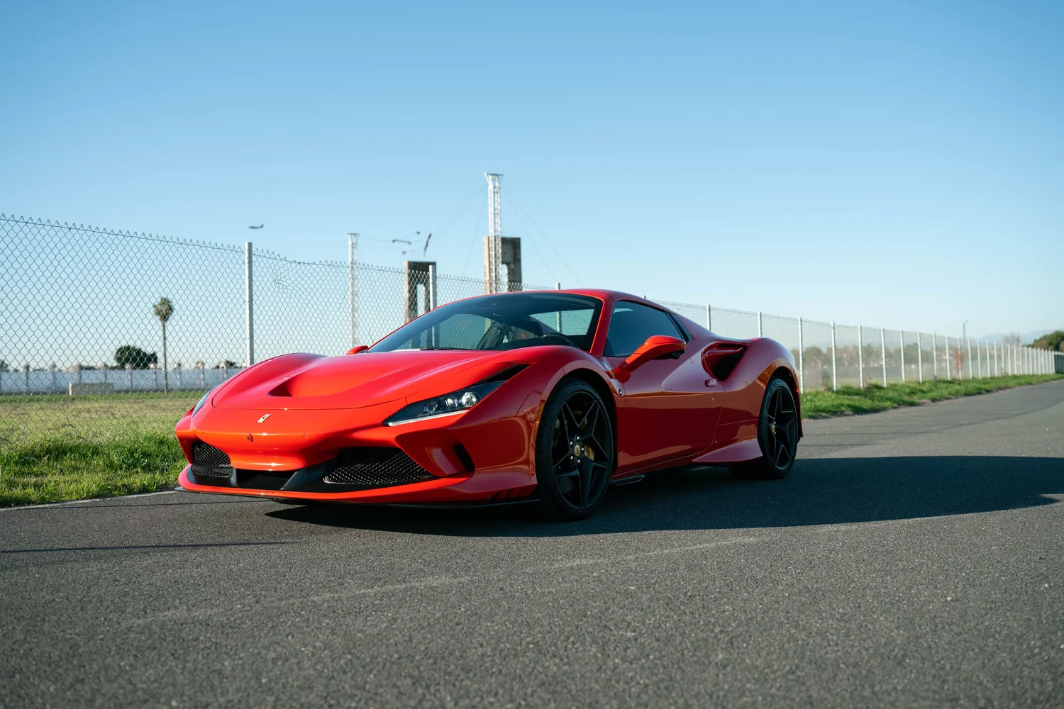 Red Ferrari F8 in complete front three-quarter view after PPF, window tint and ceramic coating