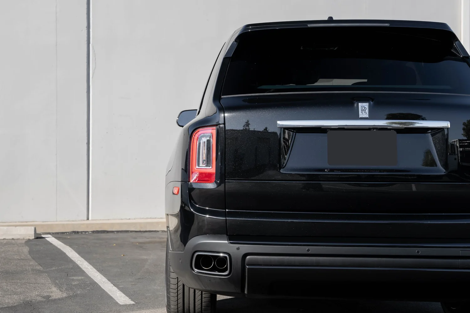 Dark Metallic Grey Rolls-Royce Cullinan after Paint Protection Film (PPF), Window Tint and Ceramic Coating, rear body and taillight view