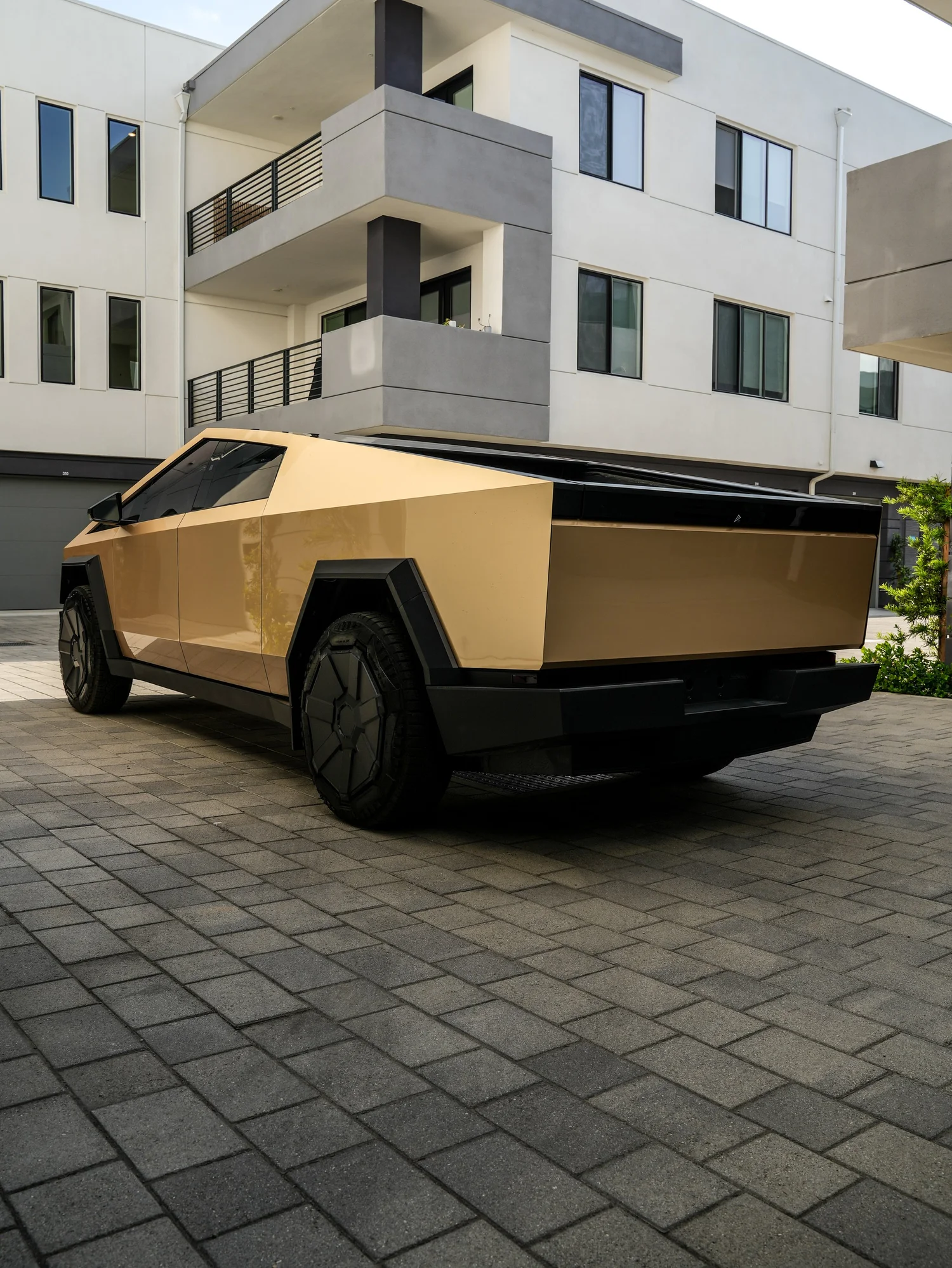 Tesla Cybertruck Milan Gold after Paint Protection Film (PPF) and Window Tint, rear-left three-quarter view