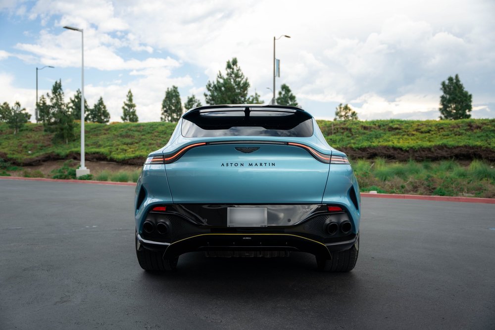 Aston Martin DBX 707 complete straight rear exterior with cloudy background