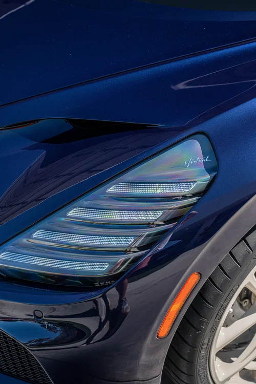 Bugatti W16 Mistral headlight close-up with Mistral script, Atlantic Blue bodywork and the front tire edge