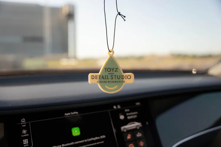Toyz Detail Studio hanging tag above the dashboard screen.