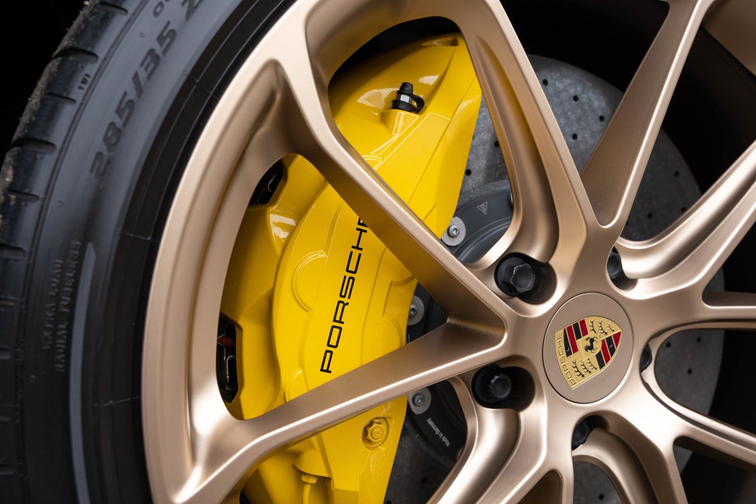 Porsche Cayenne Turbo GT bronze wheel and yellow Porsche brake caliper after PPF, window tint and ceramic coating