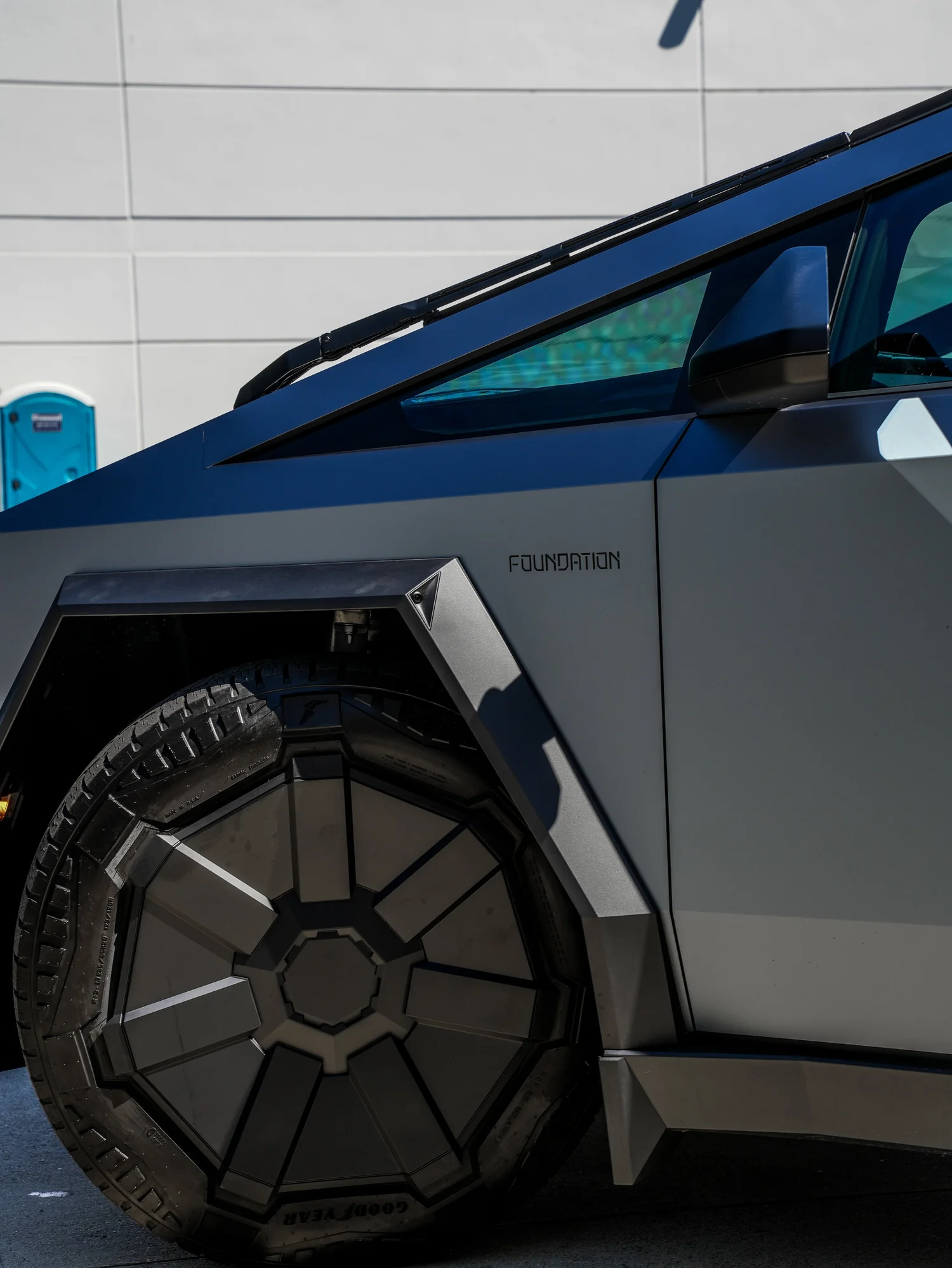 Tesla Cybertruck Ghost Metal Grey Blue after Window Tint and Vinyl Wrap, rear-quarter and wheel view