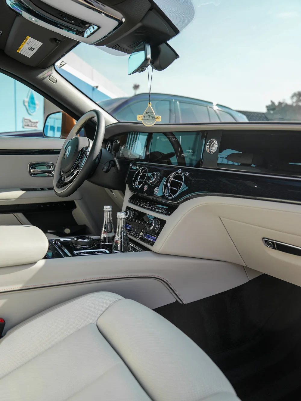 Ghost steering wheel, dashboard and center console beside the light-colored front seat