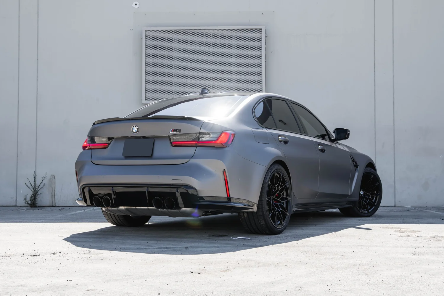 BMW M3 silver vinyl wrap, wide rear three-quarter view