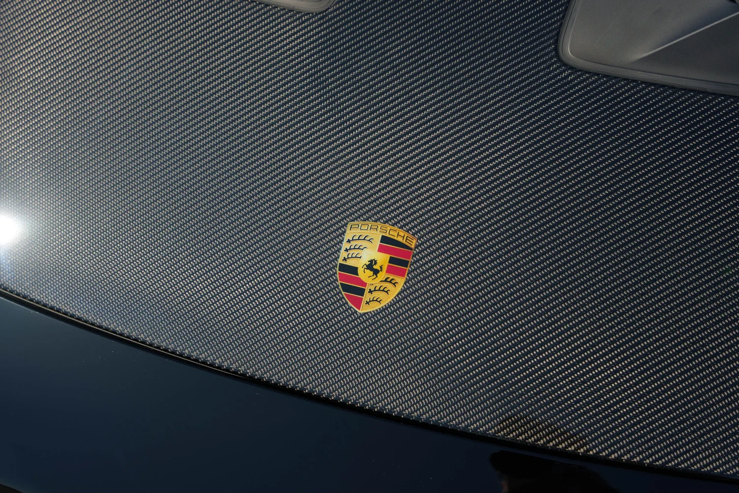 Black Porsche GT3 RS carbon-fiber hood and Porsche crest PPF detail
