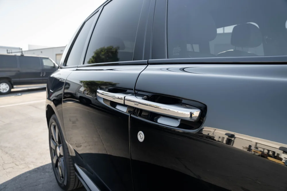 Dark Metallic Grey Rolls-Royce Cullinan — bright door handle, side glass and adjacent door-panel finish