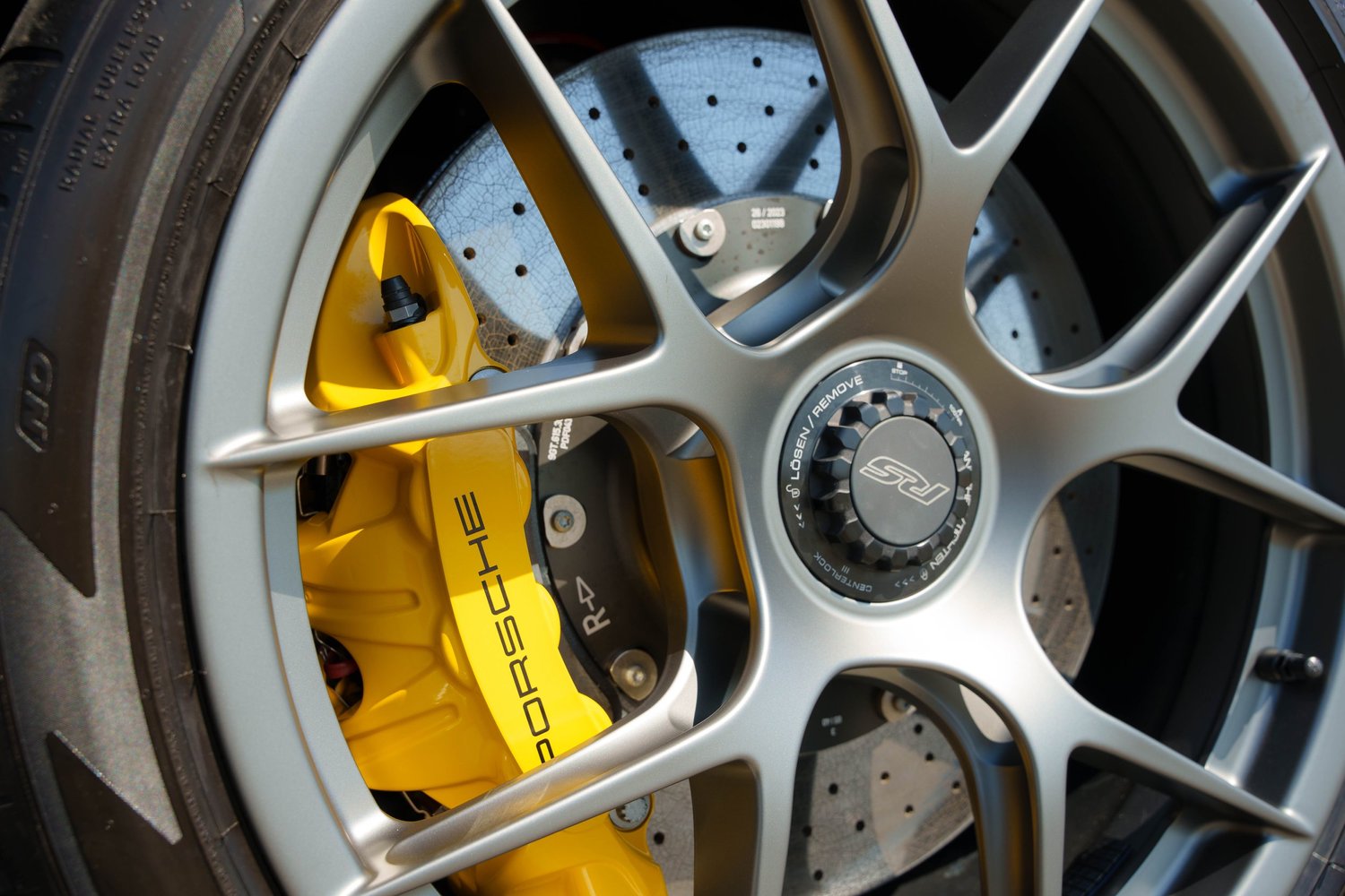 Porsche GT3 RS wheel and yellow brake caliper ceramic coating detail