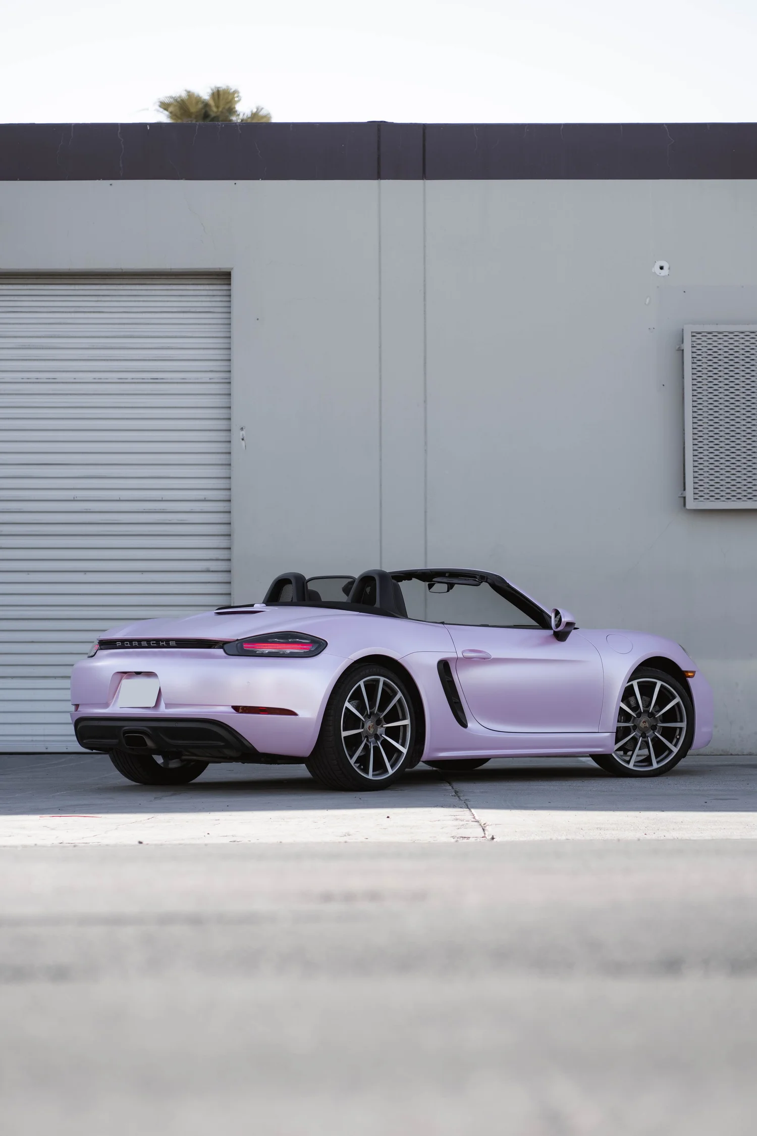 Porsche 718 Boxster Matte Purple Pink after Vinyl Wrap, front-right three-quarter view