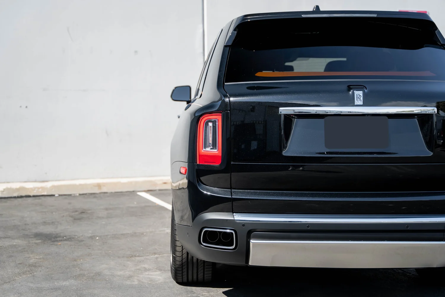 Black Rolls-Royce Cullinan with Chrome Exterior Trim after Paint Protection Film (PPF), Window Tint and Ceramic Coating, rear bumper and taillight detail