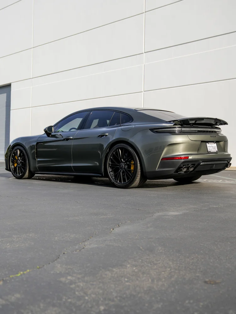 Complete rear three-quarter view of the Panamera with a raised spoiler, Turbo S lettering and four exhaust outlets