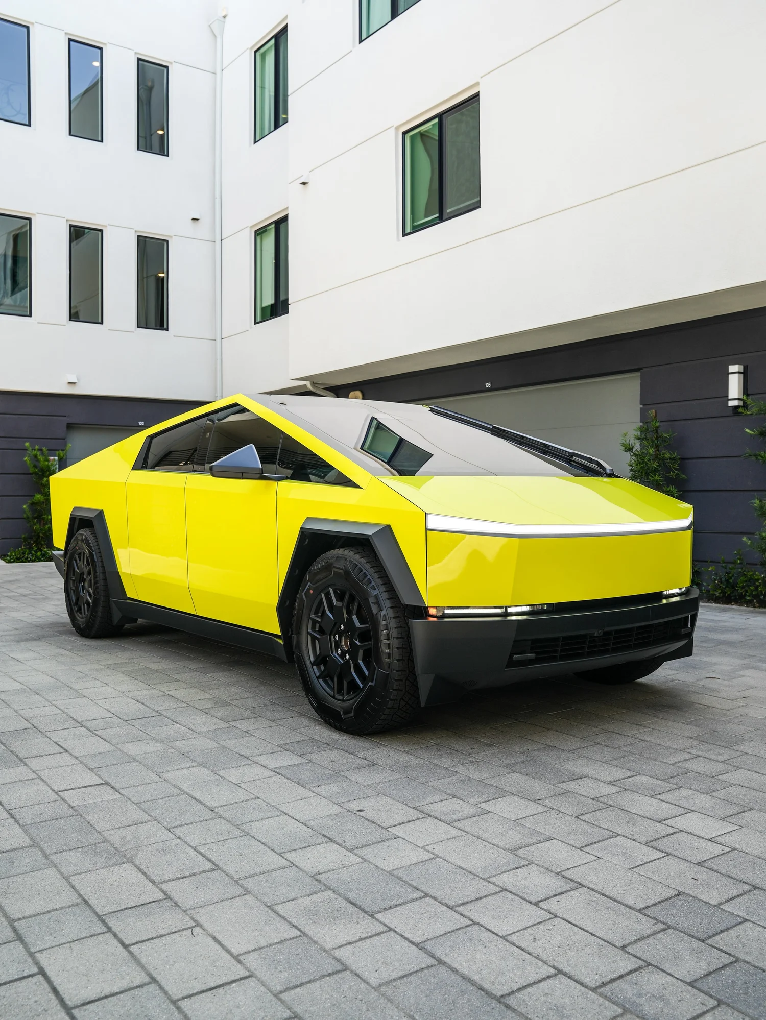 Tesla Cybertruck Inozetek Racing Yellow after Window Tint and Vinyl Wrap, front-right three-quarter view