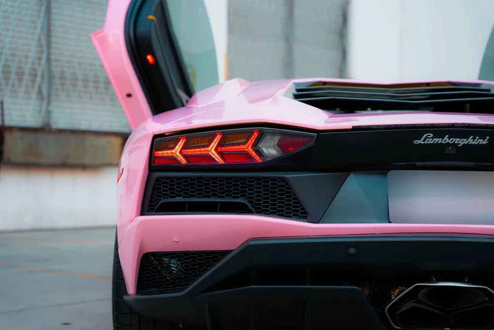 Lamborghini rear lettering, red taillight and black grille on the Sakura Pink Aventador