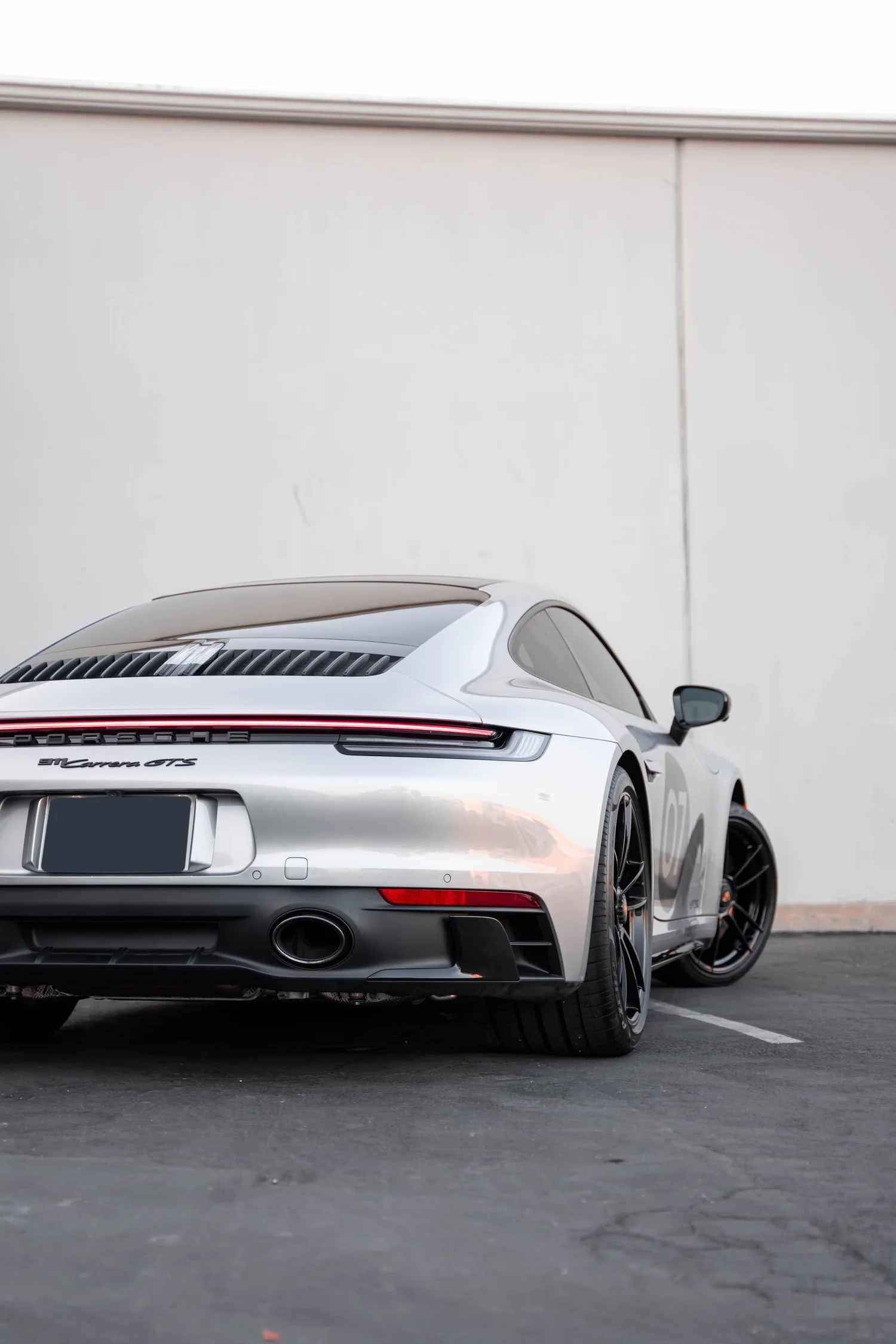Porsche 911 Carrera GTS (992.1) after Paint Protection Film (PPF), Window Tint, Ceramic Coating and Custom Graphics, low-angle rear view