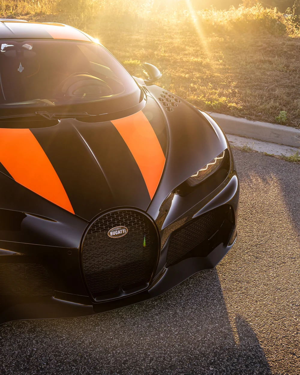 Front close-up of the Bugatti Chiron Super Sport 300+ horseshoe grille and orange hood accents