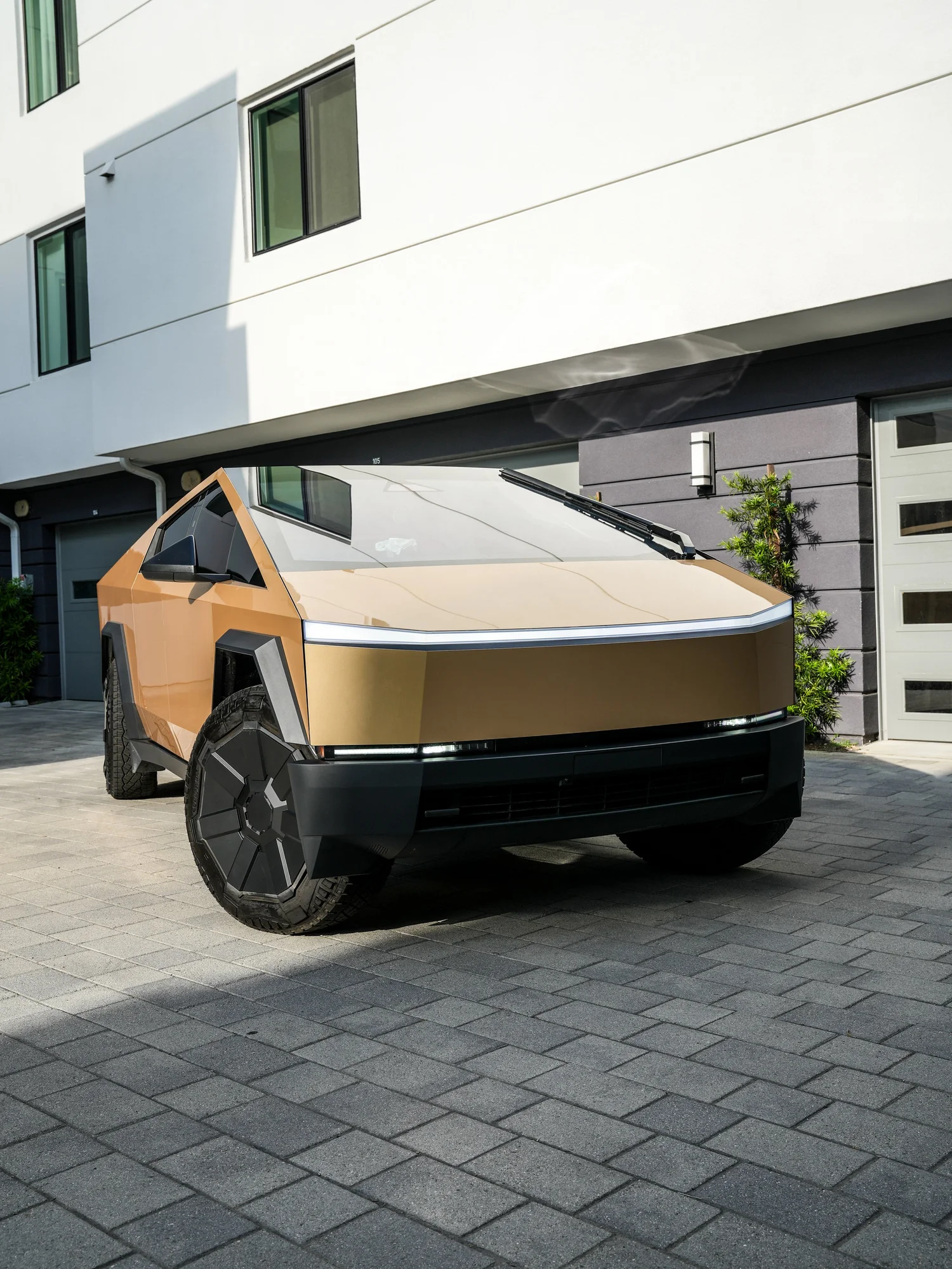 Tesla Cybertruck Milan Gold after Paint Protection Film (PPF) and Window Tint, low-angle front view