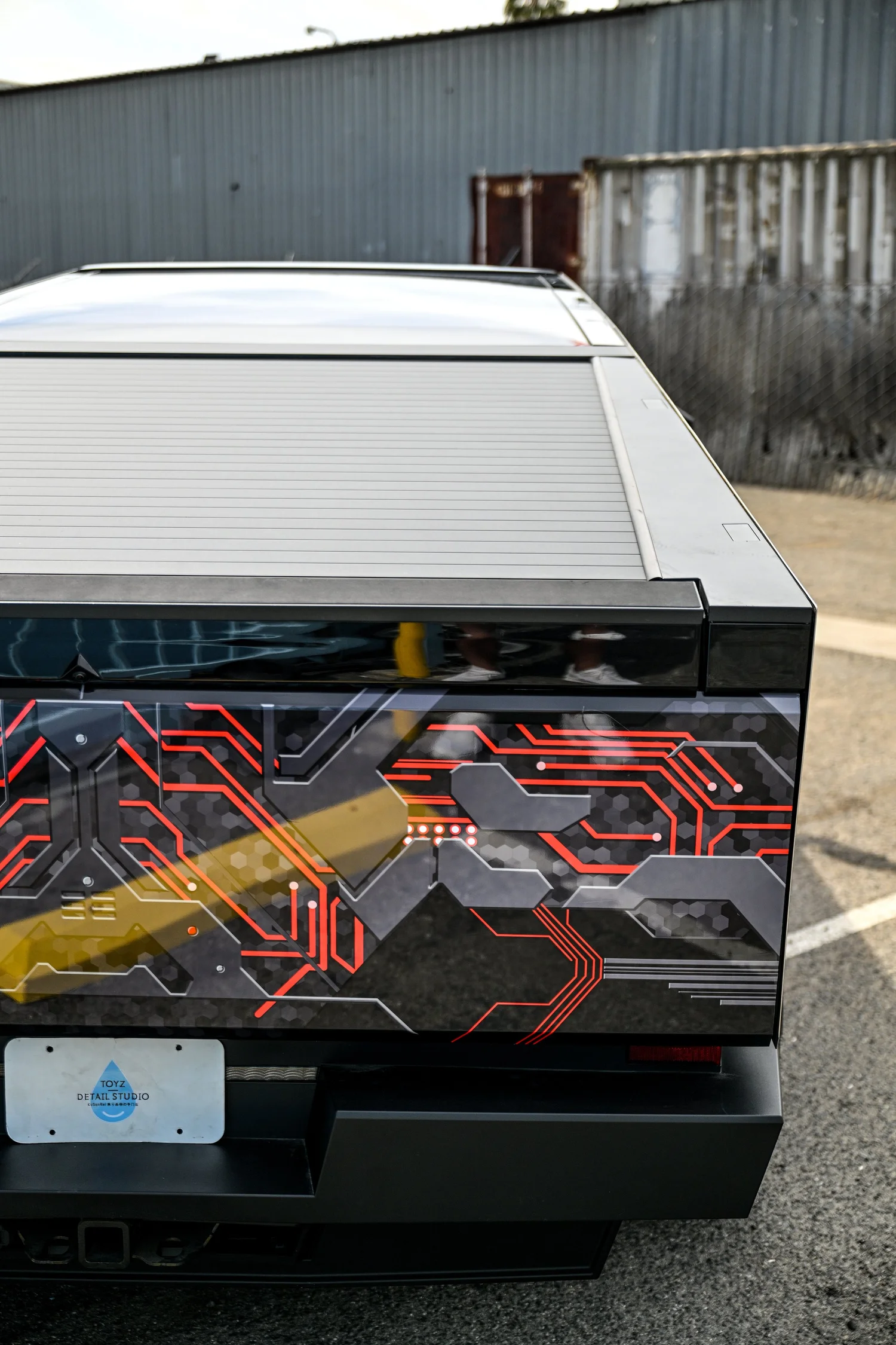 Tesla Cybertruck tailgate with red black and gray custom graphics