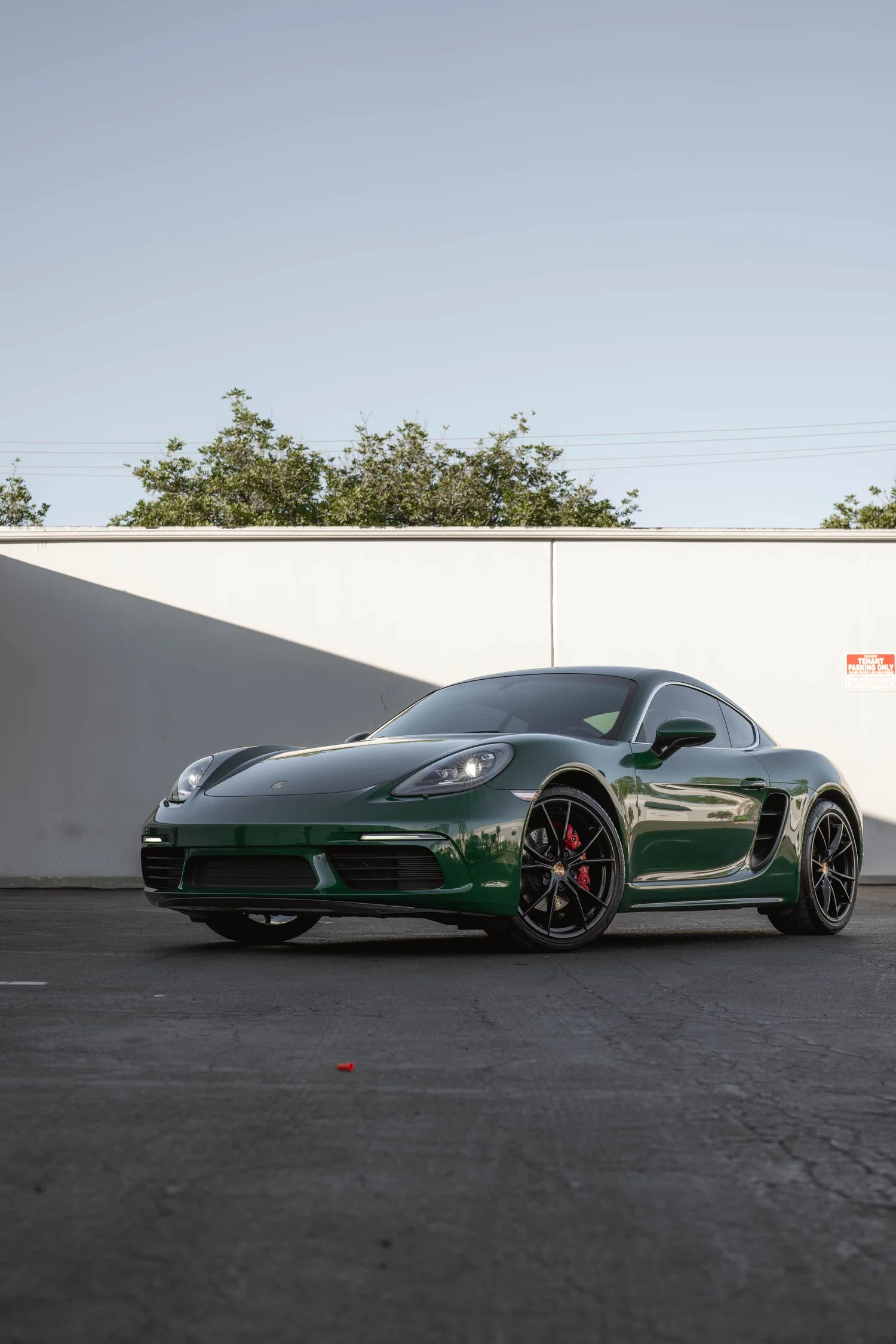 Porsche 718 Cayman S Racing Green after Vinyl Wrap, low-angle front view
