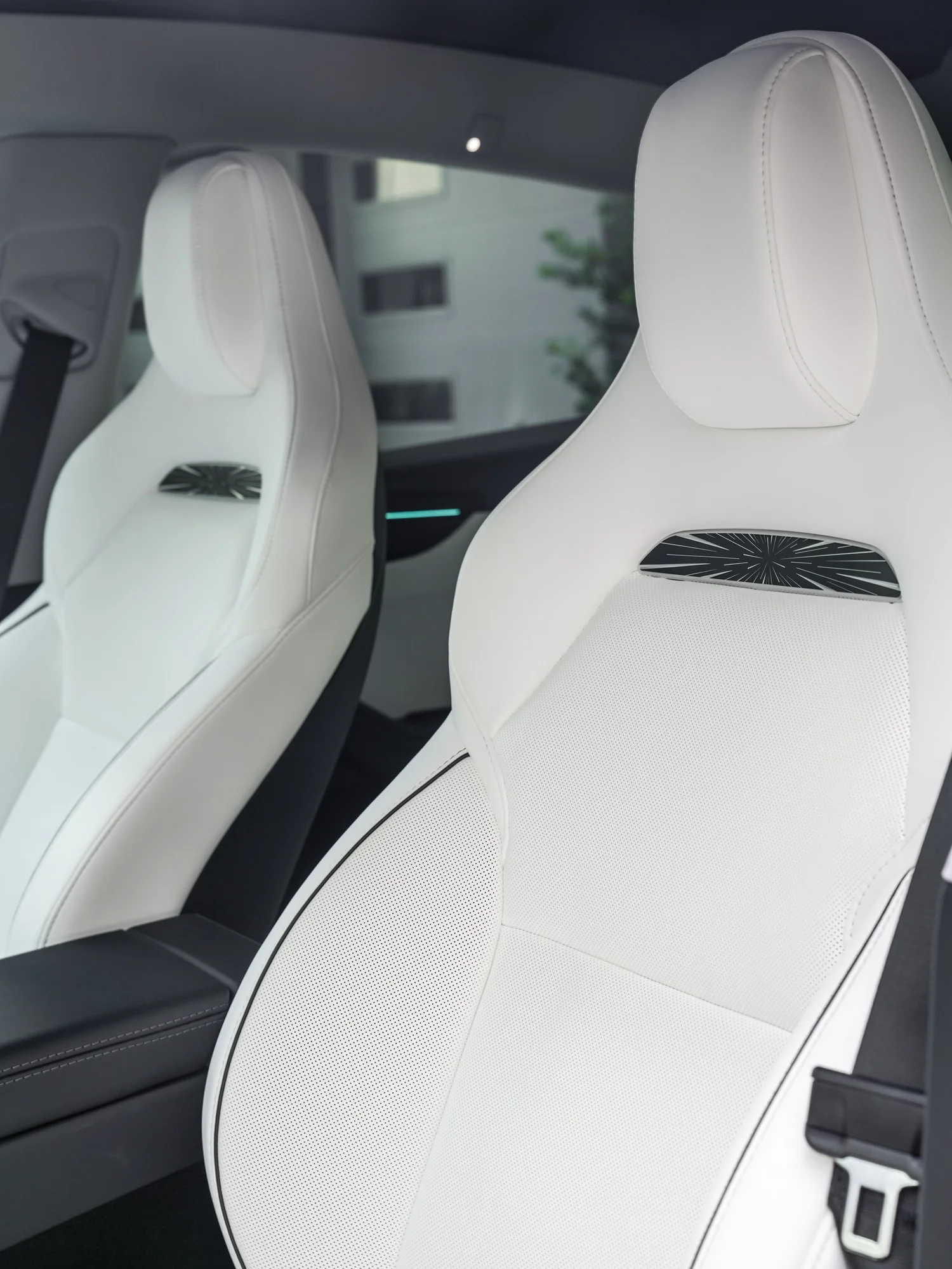 2026 Tesla Model Y Performance white front-seat and Union Jack insert detail after full XPEL STEALTH PPF and baby blue brake caliper repaint