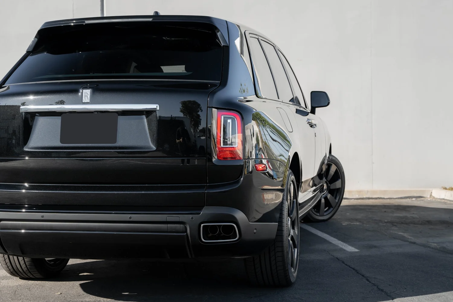 Dark Metallic Grey Rolls-Royce Cullinan after Paint Protection Film (PPF), Window Tint and Ceramic Coating, low-angle rear view